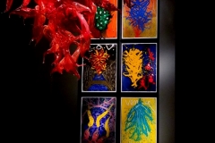 Another hanging sculpture with Chihuly's original sketches in the background